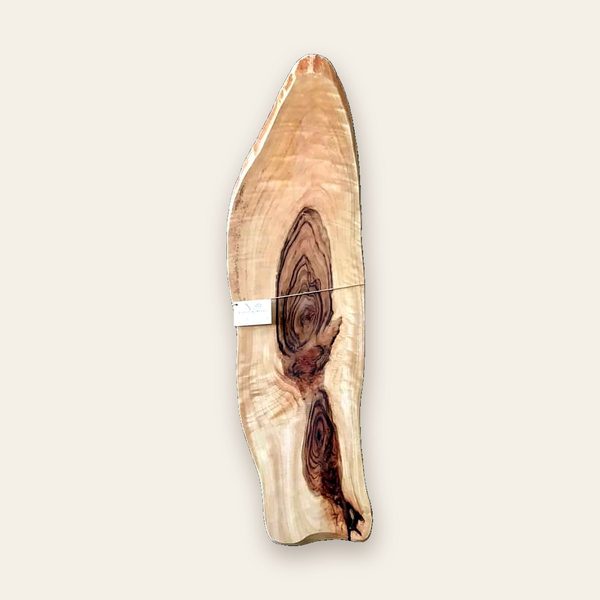 Tall oval sheoak serving board with a dark knot running through pale timber